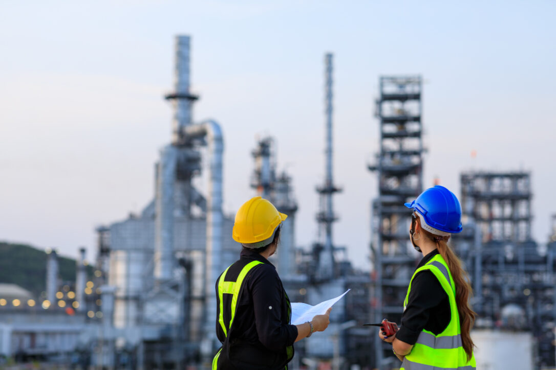 Smart two female engineer discussion together at refinery indust